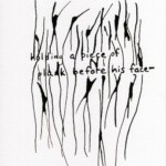 Holding a piece of plank before his face